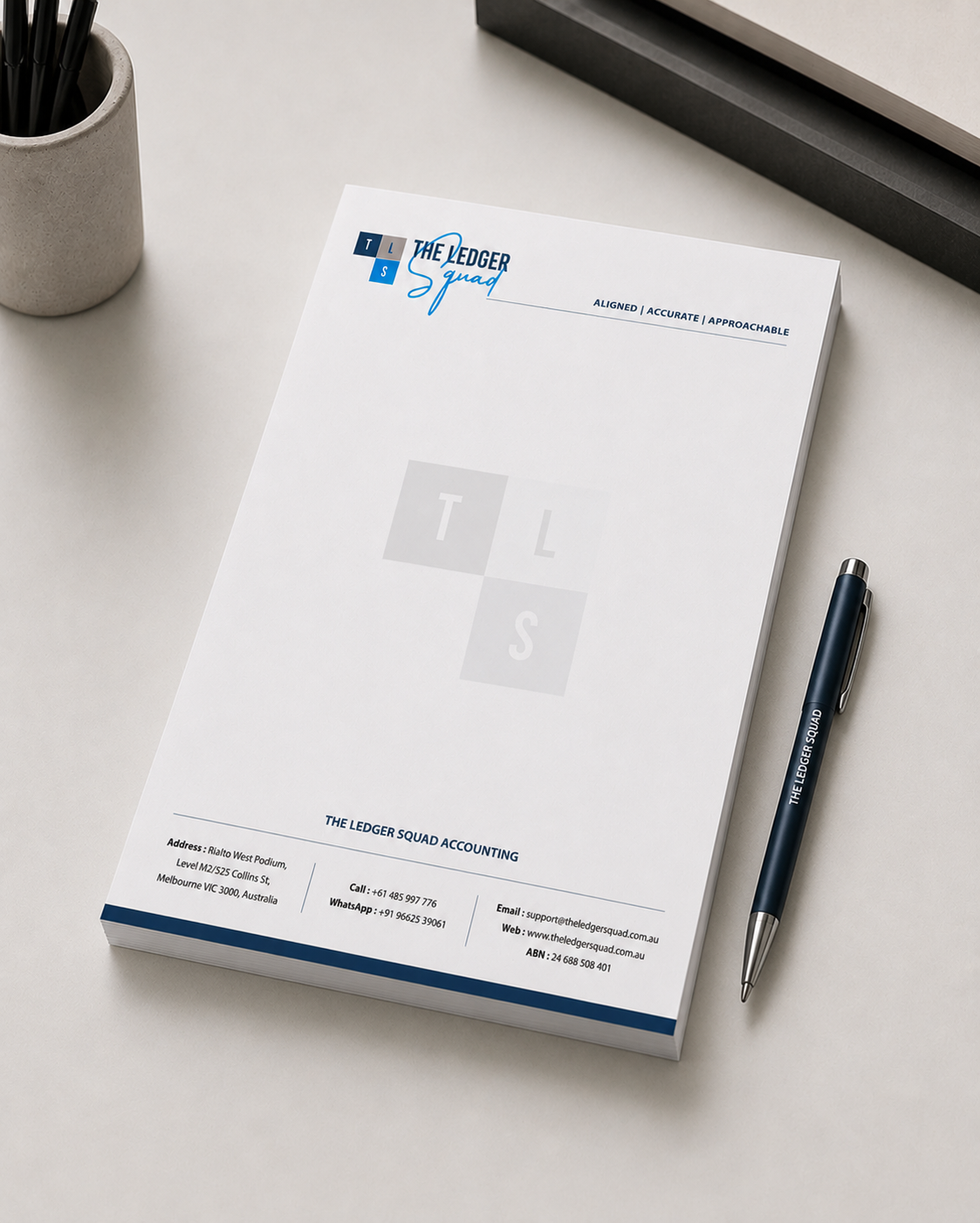 The Ledger Squad A4 letterhead on a desk with branded pen